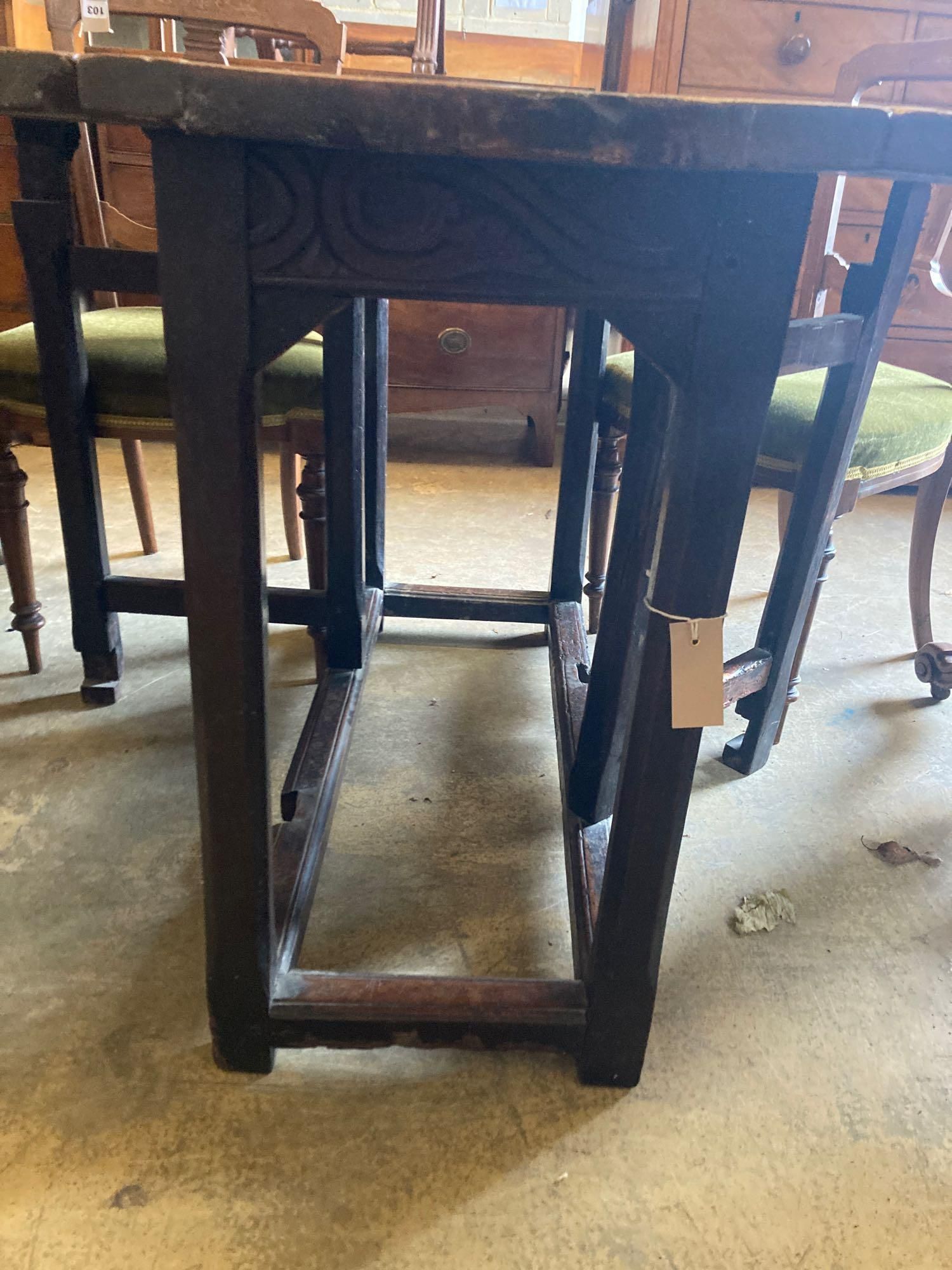 An 18th century carved and stained walnut gateleg table, with oak underframe, width 106cm, 116cm with flaps out, height 74cm